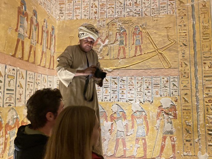 ラムセス4世の墓の壁画と写真撮影するエジプト人