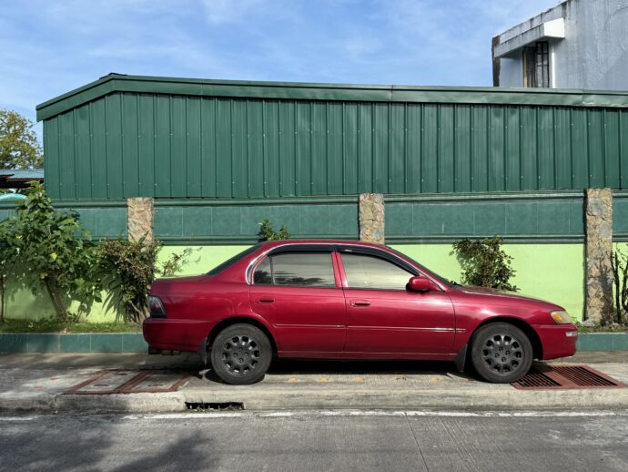 緑色の建物と赤い車