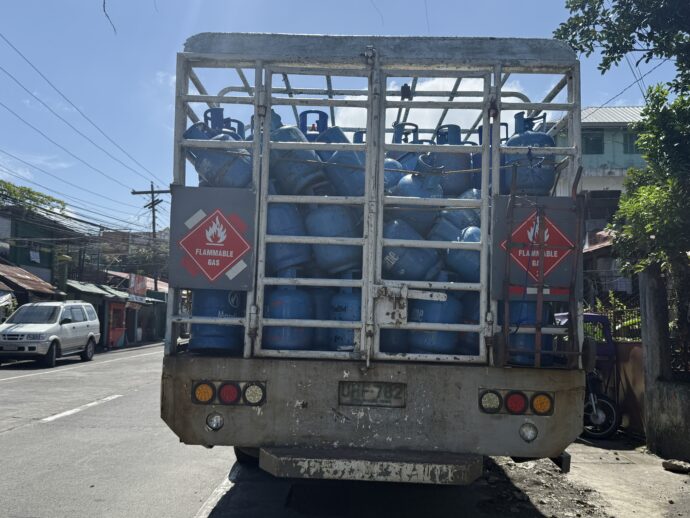 ブルーのタンクをたくさん積んだトラック